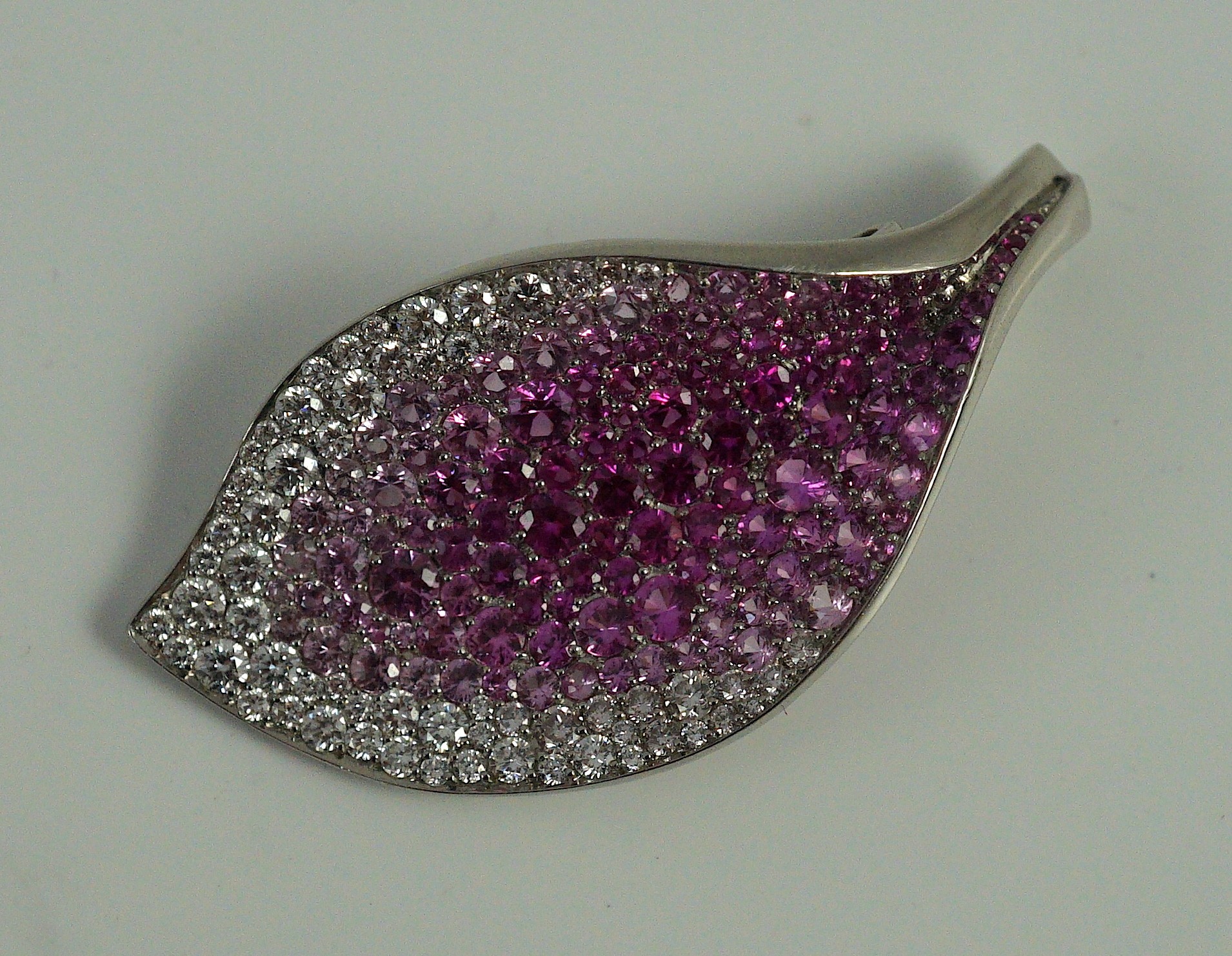 A modern Paspaley platinum and gypsy set pink and white diamond and pink sapphire cluster set leaf shaped enhancer pendant, from their Paradis collection